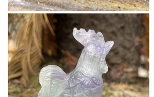 Detailed close-up of natural purple and green fluorite rooster crystal stone carving