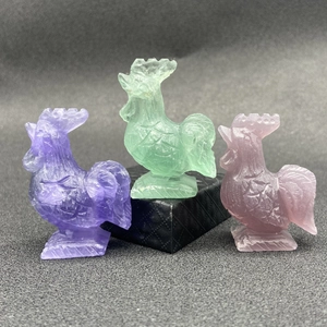 Three hand-carved natural fluorite rooster statues in purple and green crystal
