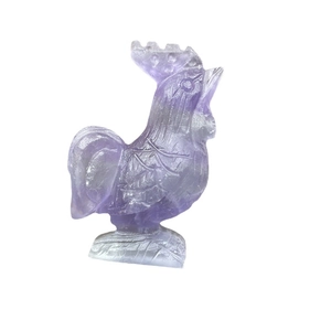 Hand-carved purple fluorite crystal rooster statue on a pedestal with natural stone patterns