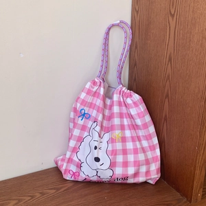Détail du sac cabas à carreaux avec cordon, motif chien et poignées en corde tressée