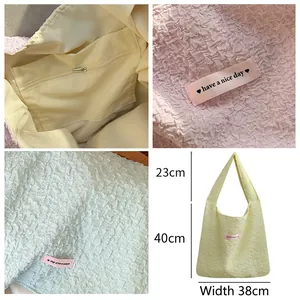 French style textured bubble tote bag with pink label shown in purple and light yellow