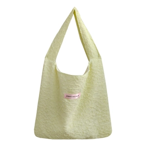 French style textured bubble pleat shoulder bag in pale yellow with a ribbon label