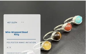 Detail of wire-wrapped bead rings in multiple gemstones and silver-toned wire finish