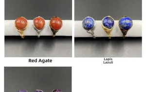 Detail of handmade wire wrapped rings with red agate and lapis lazuli gemstones