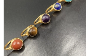 Detailed view of handmade wire-wrapped rings featuring round semi-precious gemstones