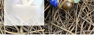 Macro detail of handmade gold wire-wrapped natural crystal beads pendant
