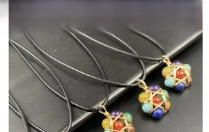 Macro detail of wire-wrapped seven chakra natural stone pendants in star shape