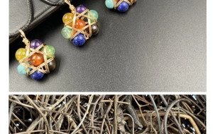 Macro shot of colorful natural stone beads wrapped in a gold wire star-shaped pendant