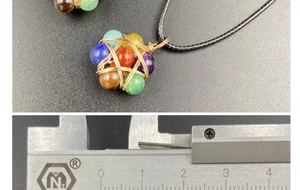 Detailed view of handmade seven chakra stone pendant with golden star wire wrap
