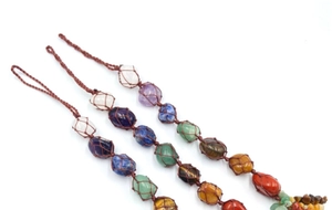 Detail of handcrafted macrame pendants featuring seven types of raw natural healing crystals