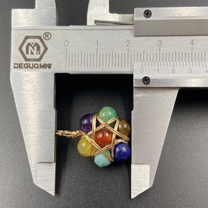 Handmade wire wrapped natural stone star pendant measuring 25mm with colorful gemstones