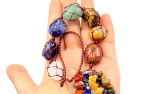 Close-up of hand-woven Seven Chakra healing crystals hanging ornament with natural raw stones