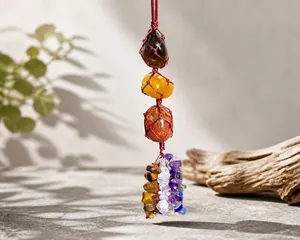 Detail of colorful natural tumbled stones handcrafted into a healing crystal car hanging