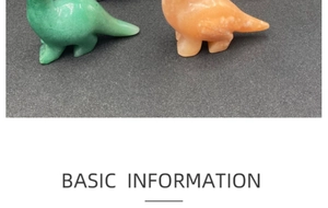 Detail view of hand-carved natural gemstone dinosaurs in green and orange crystal