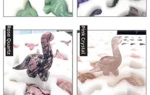 Macro detail of hand-carved rhodonite and rose quartz dinosaur gemstones with smooth finish