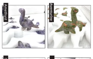 Detail of hand-carved Amethyst and Unakite dinosaur figurines with polished natural texture