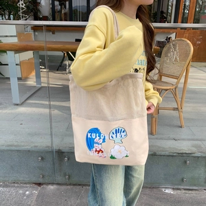 Outdoor lifestyle shot of a mesh patchwork tote bag with cartoon sea wave patterns