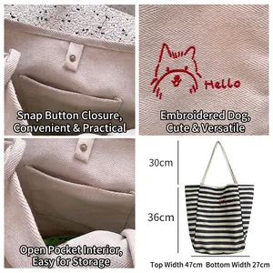 Large striped canvas tote bag with red puppy embroidery and snap closure detail