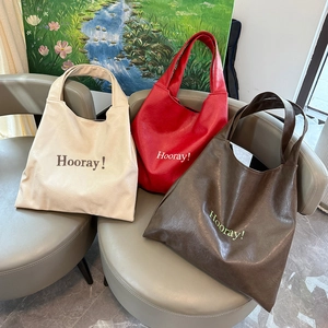 Three minimalist soft faux leather tote bags with Hooray text print in various colors