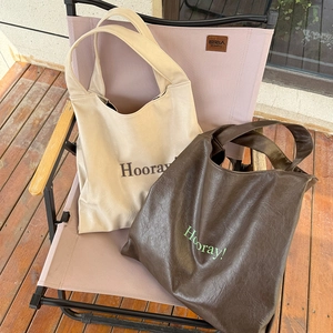 Minimalist soft leather tote bags in cream and brown with letter print for commuting
