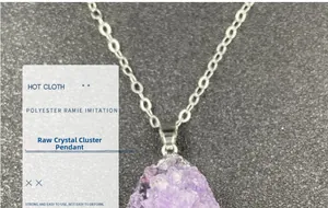 Macro shot of natural purple amethyst crystal cluster pendant with a silver-plated edge