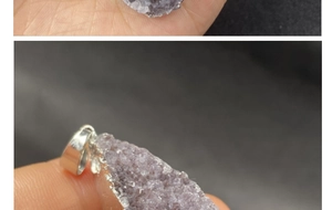 Detailed macro view of raw amethyst crystal pendant with silver electroplated edges