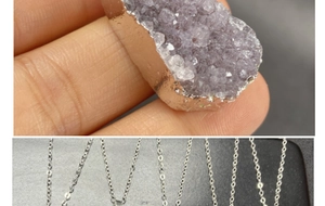Close-up of raw amethyst crystal cluster pendant with electroplated silver edges