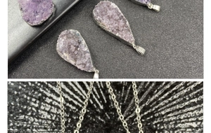 Macro view of teardrop amethyst druzy pendant with polished silver plating finish