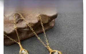 Dettaglio del ciondolo in perla barocca fatta a mano con filo d'oro e catenina