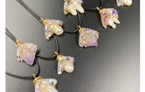 Detailed wire-wrapped amethyst and pearl pendants on black braided cords