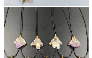 Close-up of handmade purple amethyst and pearl pendants with gold wire wrapping details