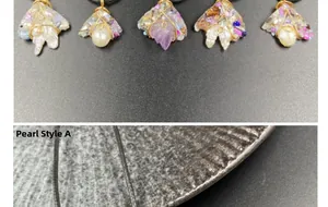 Detail of handmade amethyst and pearl wire wrapped pendants with intricate metal craftsmanship