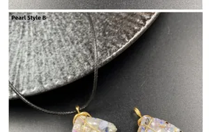 Detail of Pearl Style B wire wrapped pendant with amethyst chips on black stone base