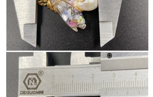 Macro detail of handmade wire-wrapped amethyst and pearl pendant measured with a caliper