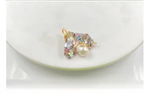 Detailed wire-wrapped insect pendant crafted with gold metal, pearl, and colorful shell pieces