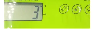 Macro view of bright green kitchen scale LCD display with circular function buttons