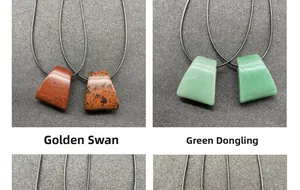Detailed view of fan-shaped Golden Jasper and Green Aventurine pendants with cord