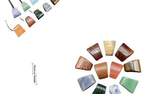 Close-up of trapezoid natural agate and stone pendants in multiple colors and textures