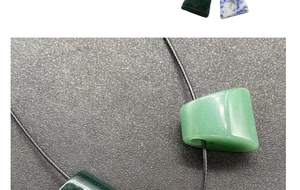 Macro detail of polished natural agate trapezoid beads in green and blue stone tones