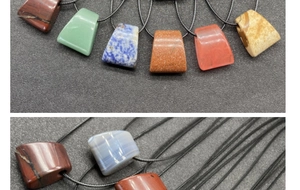 Close-up of trapezoid natural stone pendants in agate and lapis with black cords
