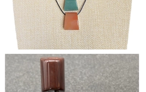 Detail of fan-shaped green aventurine and red agate pendants on a black cord necklace