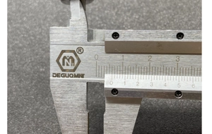 Detailed macro view of precision metric scale and logo on stainless steel vernier caliper