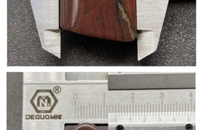 Caliper measuring a reddish-brown natural agate fan pendant with black banded textures