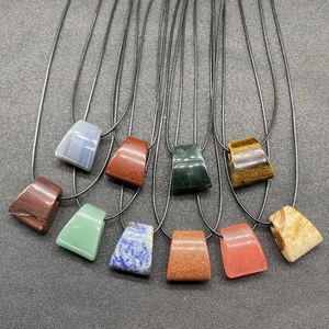 Assorted natural agate and crystal trapezoid pendants on black woven necklace cords