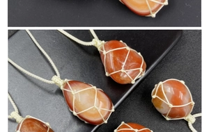 Macro shot of natural red agate stone pendants with handcrafted woven mesh nets