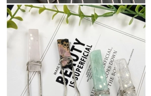 Detail of natural raw stones wrapped in silver wire on elegant gift cards
