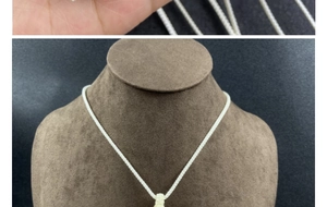 Detail of red agate stone necklace with woven mesh bag pendant on mannequin