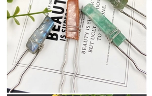 Detail of handmade wire-wrapped crystal hairpins with colorful irregular gemstones