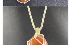Macro shot of large red agate teardrop stone in a handcrafted beige woven mesh pouch