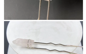 Close-up of pink crystal hair stick with handmade wire-wrapped U-shape metal pin